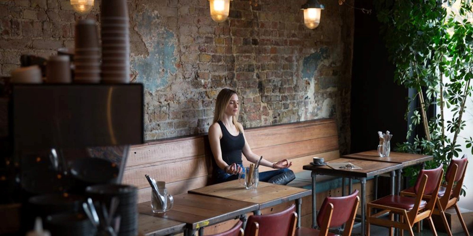 Women Meditating In Cafe